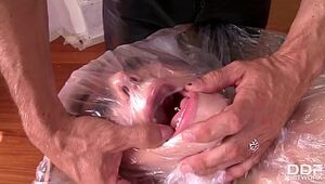 Subordinated Leyla Dark-hued wraped in plastic and gloppy tape for ass-fuck fetish
